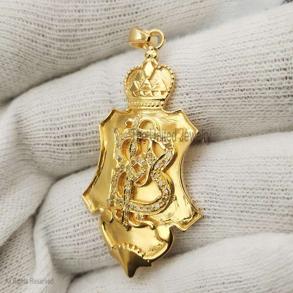 Material: Authentic 925 Sterling Silver. Plating: Premium 14K Gold Finish for a luxurious, high-shine appearance. Gemstones: Brilliant Pave-set Diamonds (or high-grade CZ) encrusting the central initial. Design: An architectural shield silhouette topped with a detailed royal crown. The center features a stylized, diamond-set script initial "B". Style: Heritage and Luxury; a bold, crest-inspired pendant that combines regal symbolism with personalized elegance. Bail: Polished gold-plated bail designed to fit a variety of classic chain styles.